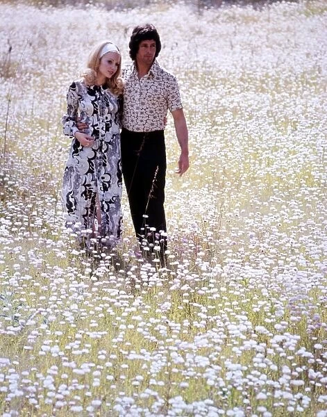 Couple walking through a field of daisies love couple romance romantic for valentines