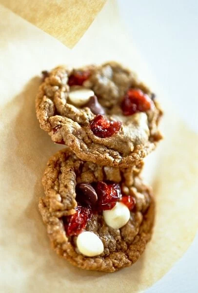 Cranberry and peanut and chocolate chip cookies on greaseproof paper credit: Marie-Louise
