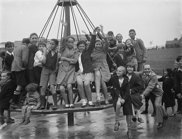 Crayford playground is opened. Children swing on the maypole swing