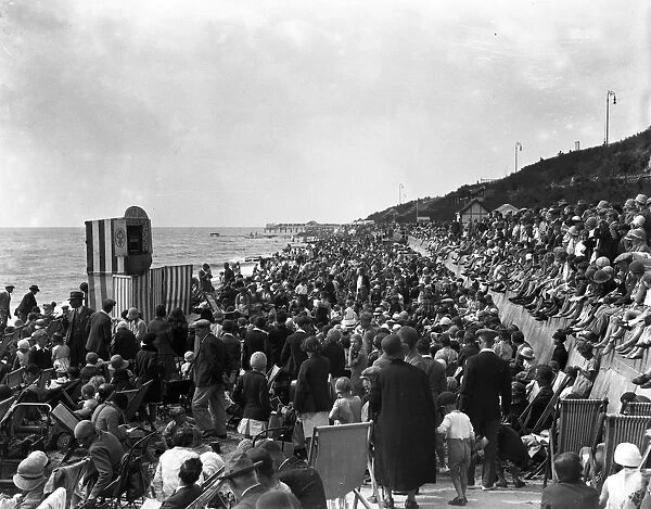 Crowds watch a Punch and Judy show on the beach at Clacton - on - Sea, Essex. 24