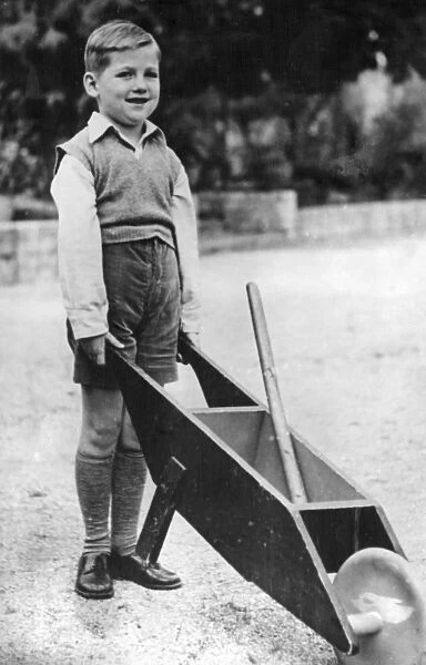 Crown Prince Constantine of Greece aged 6, with a wheelbarrow in the garden of the Royal Palace