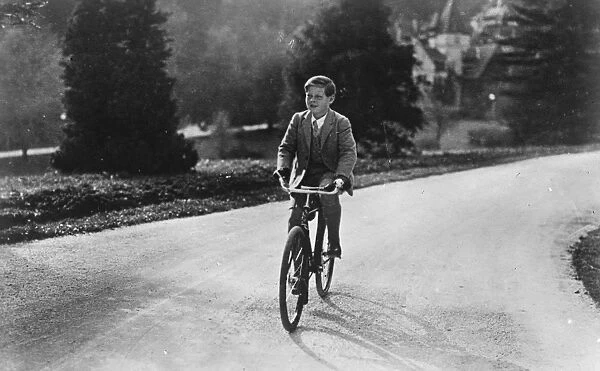 A cycling King. King Michael of Romania cycling in the grounds of his Palace at Sinaia