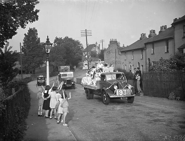 The Dartford Carnival Queen with her attendees parade on a lorry wave to the crowd
