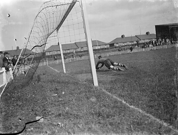 Dartford versus Guildford football match. Goal mouth action, the goalkeeper dives