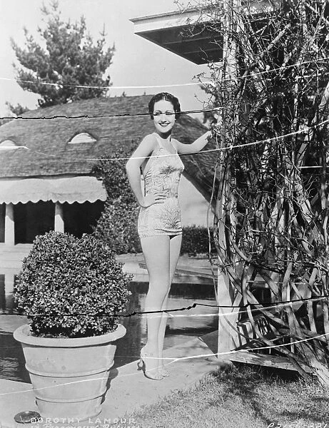 A dazzling new bathing creation of printed material worn by Dorothy Lamour, the Hollywood