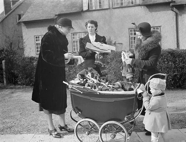Delivering gas masks by pram to families in Sidcup, Kent. Mrs Topham and Mrs