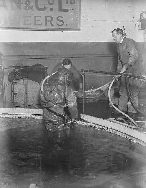 Demonstration of divers at work at Siebe. Gorman and Cos tanks at Westminster