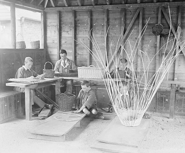 A disabled soldier and children basket weaving at the Princess Louise Military Orthopaedic
