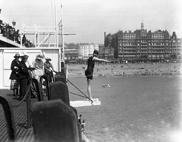 Diving off the pier during the Whitsun holiday at Brighton. 1920
