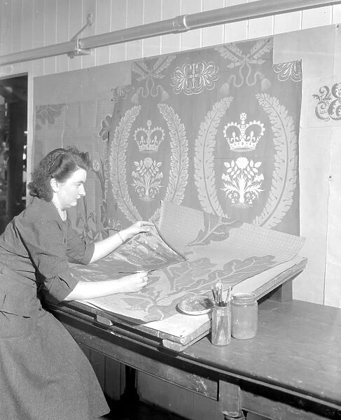 Draughtswoman Miss June Swindells working on designs for the draperies for the Coronation