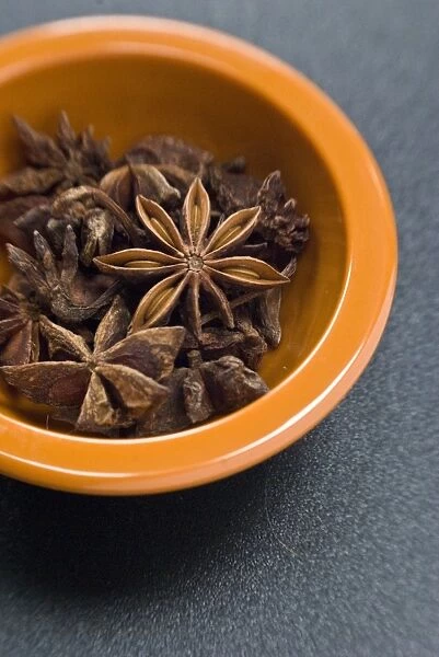 Dried Star anise fruits in small bowl. Also known as star aniseed, badiane or Chinese