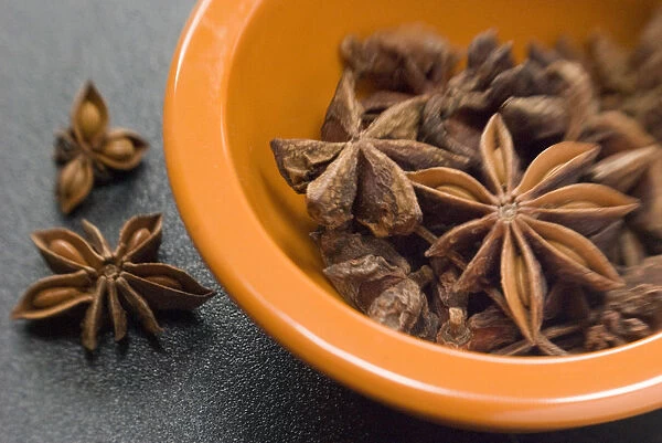 Dried Star anise fruits in small bowl. Also known as star aniseed, badiane or Chinese
