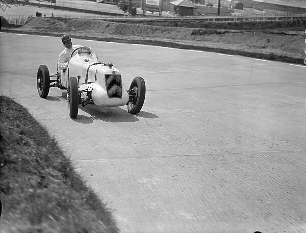 Driver, W Esplen in his supercharged MG taking the last hill on the new road track at Brooklands