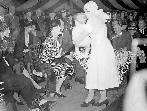 Duchess of Kent, receives purse from youngest baby. The Duchess of Kent, receiving