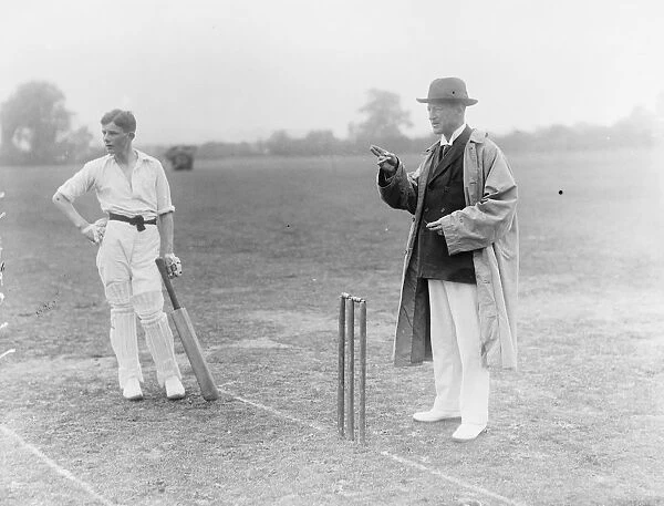 Duke of Marlborough acts as umpire at cricket match between two teams of Oxford schoolboys