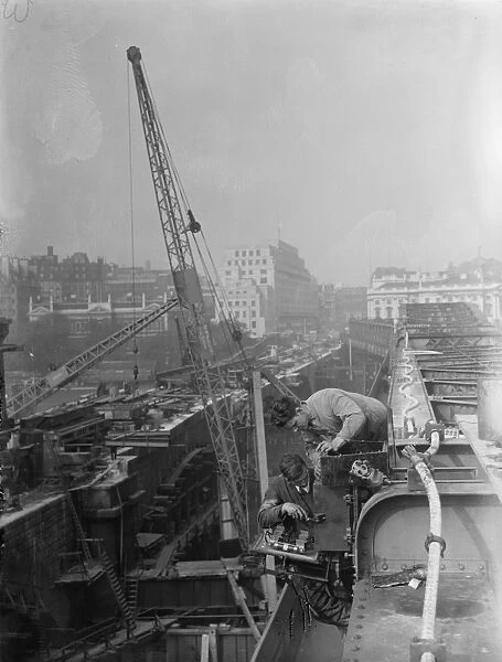 Electricians at work on a switchbox on top of the temporary Waterloo Bridge, London