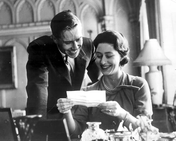 Engagement picture of Princess Margaret and Anthony Armstrong Jones reading a telegram