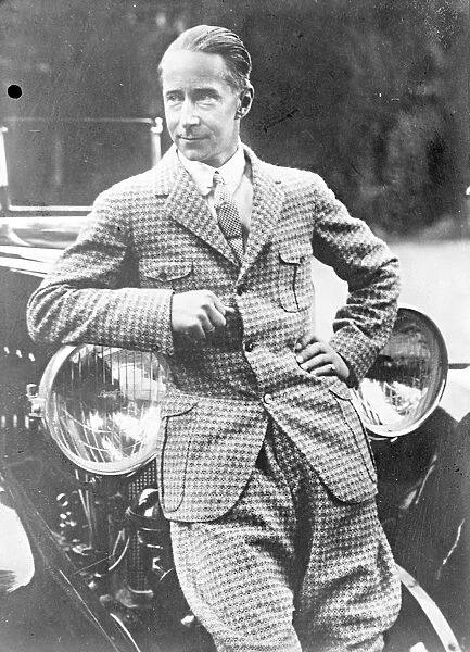 Ex-Crown Prince Wilhelm of Germany leaning on a car in his holiday suit. [son of