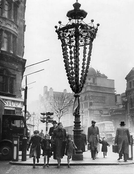 An example of decorated lamp standards to Holborn W C during a test of street decorations