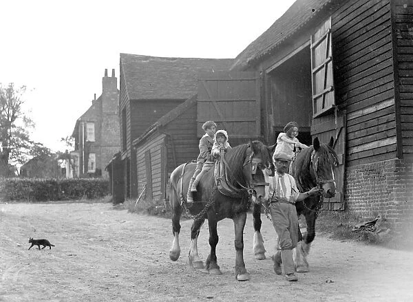 Farm scene: children on horses in the evening. 1934