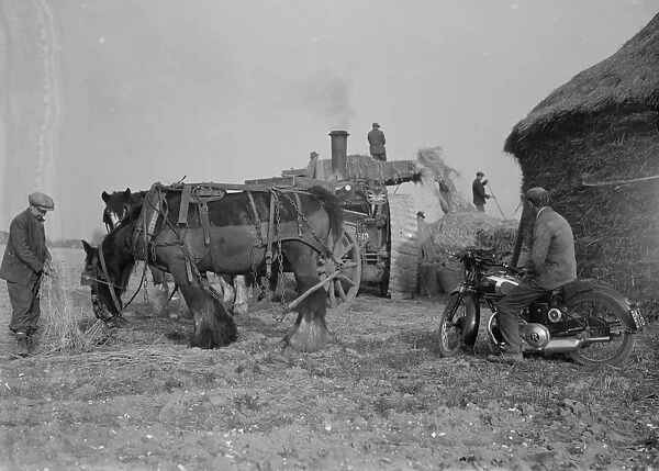 Farm workers in Farningham, Kent at work using a portable steam engine and belt-driven