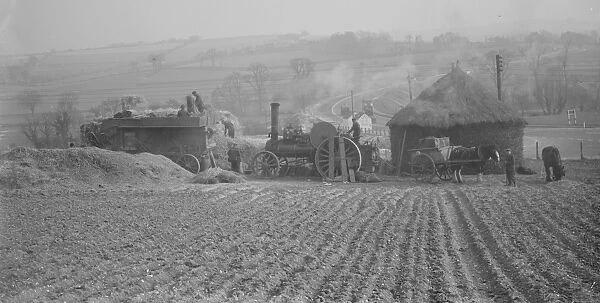 Farm workers in Farningham, Kent, at work using a steam engine and belt - driven