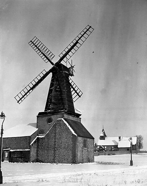 First snow of winter. This old windmill beside the little church at Hove, Sussex