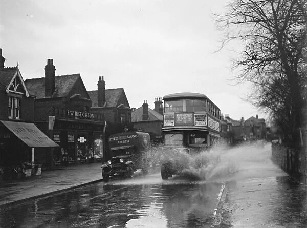 Flooded streets in Sidcup, Kent. Double dekker bus plows through the water