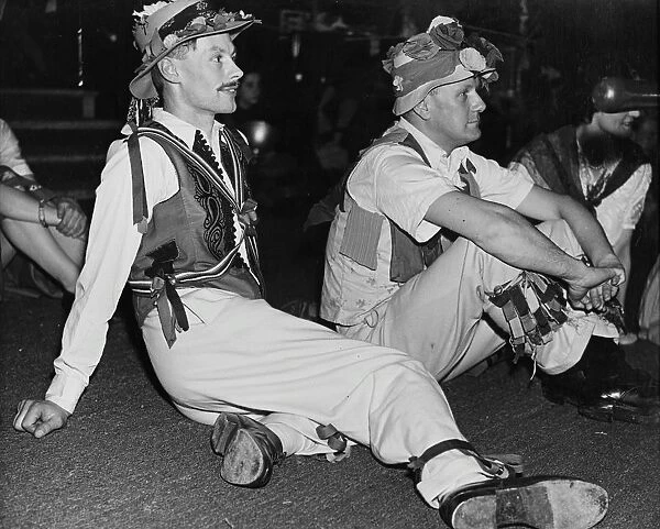 Folk Dance Festival. Lads from the country take a breather: their costumes are adorned