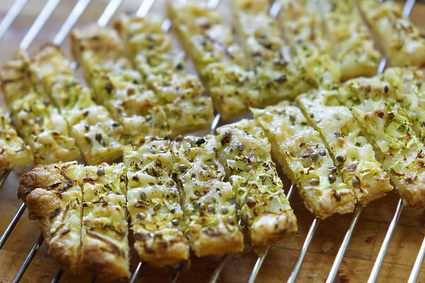 Freshly baked cheese straws cooling on rack, made with grated courgette and grated