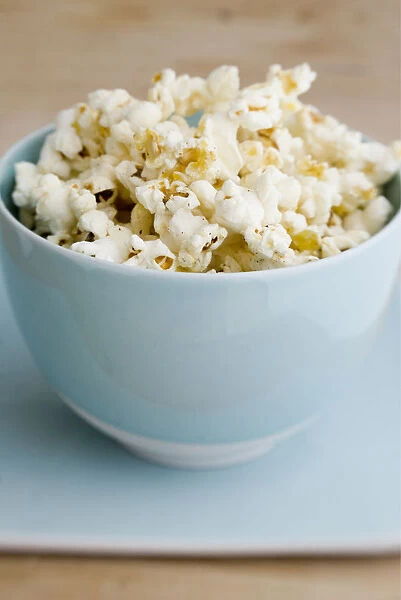 Freshly popped pocorn in pretty blue bowl credit: Marie-Louise Avery  /  thePictureKitchen