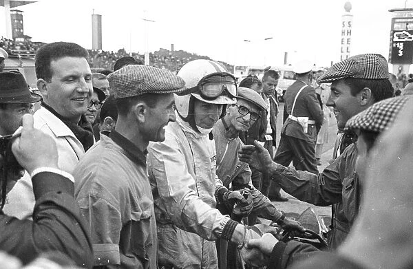 Friends and fans gather round to congratulate John Surtees after he won the German