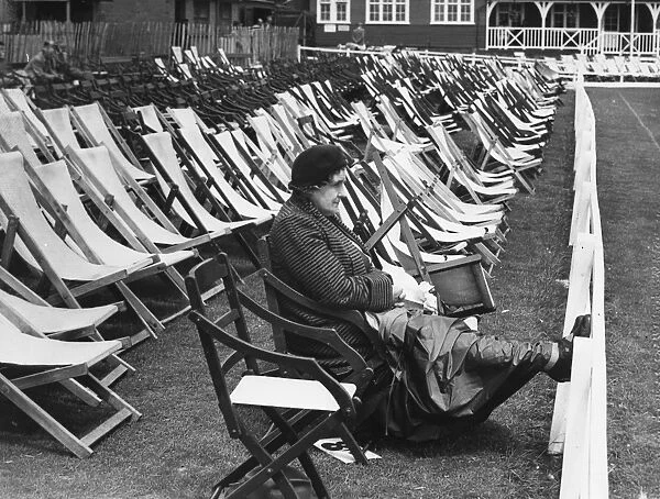 In glorious isolation, this hardy woman cricket enthusiast sat in the reserved