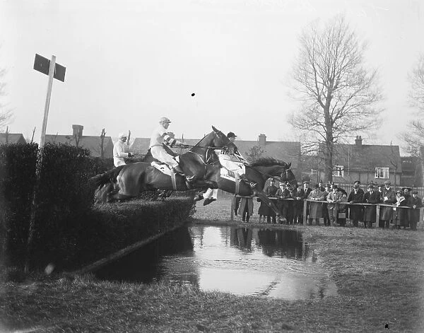 Grand Military Meeting at Sandown Taking the water jump in the Talley, Ho Hunters