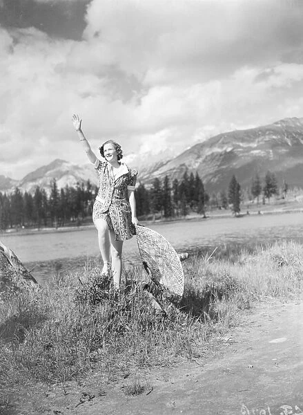 Greetings from the Canadian Rockies. A charming holidaymaker takes her giant hat off
