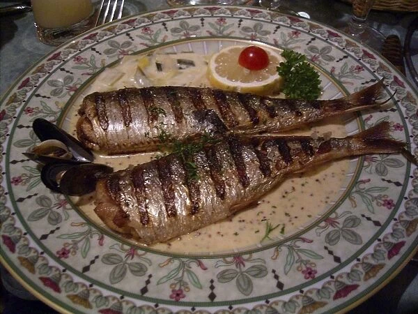Grilled herring served in a sauce on a dinner plate in a restaurant, Dieppe, Seine-Maritime