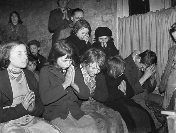 Gypsy childrens Sunday school in the cow shed in St Mary Cray. Children praying