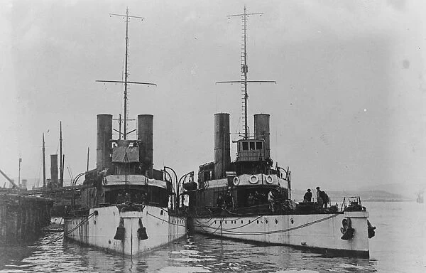 HMS Cockchafer and HMS Cricket the Insect-class gunboats wait at their moorings