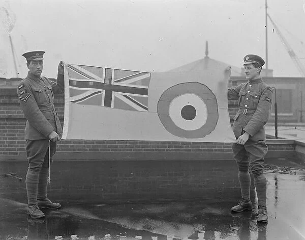 Hoisting the new Royal Air Force ensign. Members of the RAF with the Flag before