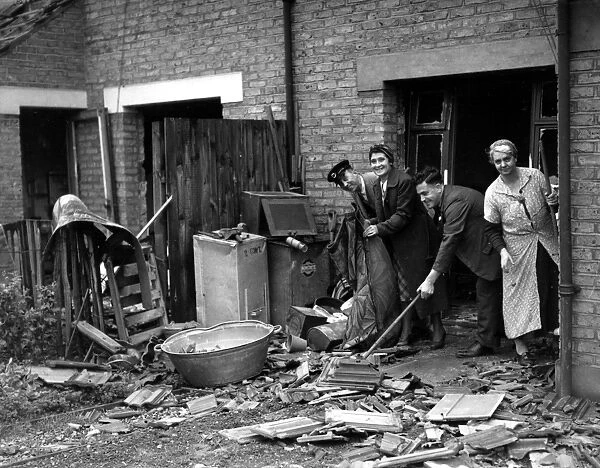 Home front 1940 A bus driver cleans debris from an air raid up before reporting