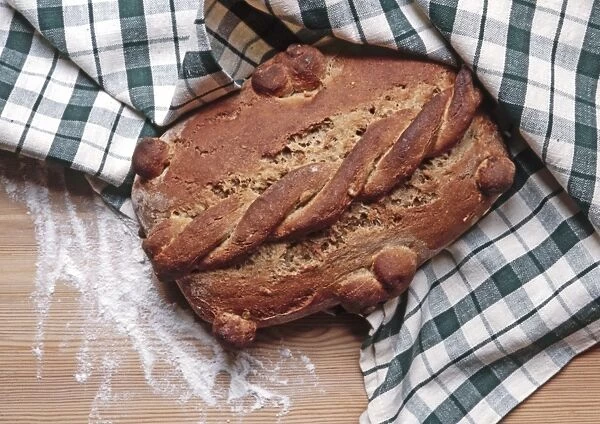 Home baked rye bread with twisted decoration credit: Marie-Louise Avery  /  thePictureKitchen