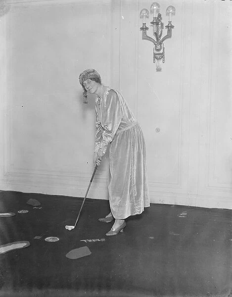Hyde Park Hotel Christmas fair. The Duchess of Hamilton playing golf on the drawing