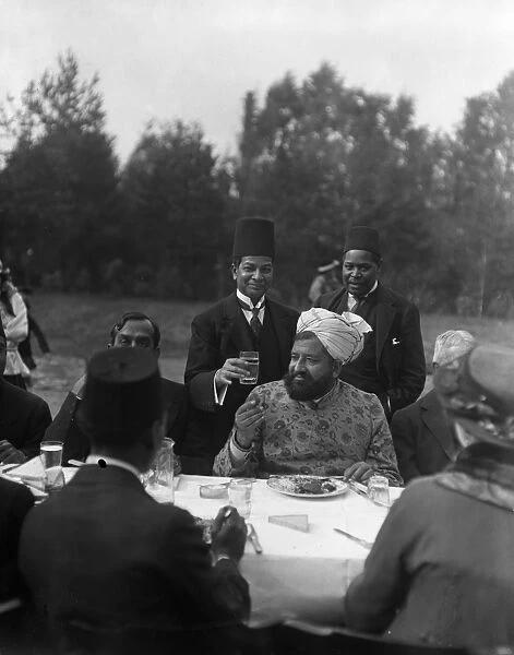 The Imam eating during the Feast of Sacrifice in the gardens of the Mosque in Woking, Surrey