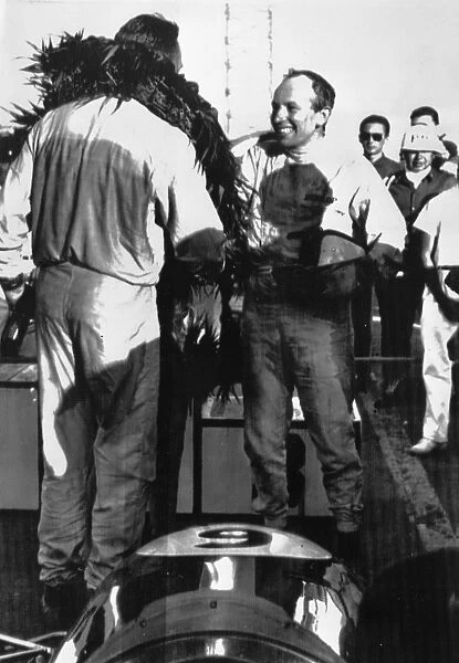 John Surtees congratulates Mexican Grand Prix winner Dan Gurney of Costa Mesa California