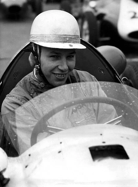 John Surtees world champion motor cyclist who has taken up motor car racing at the