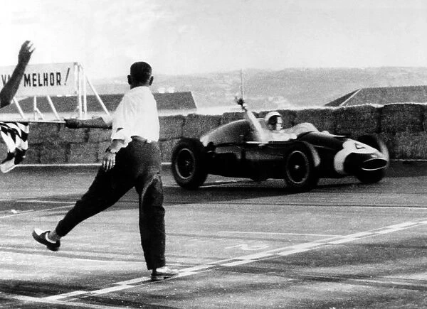 The judge flags in the winner of the Grand Prix Monsanto 1959 at Lisbon, Stirling