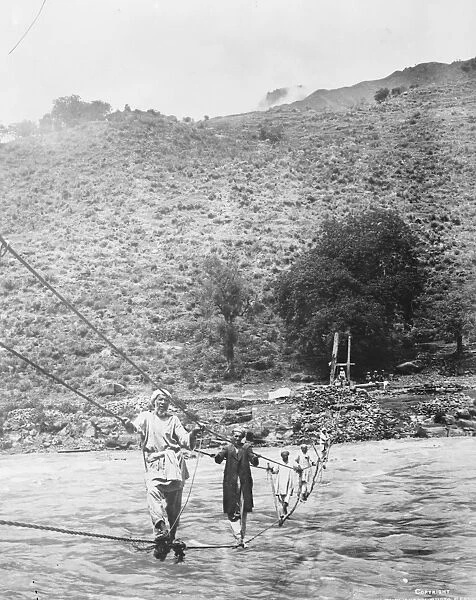 Kashmir, India A rope bridge across the Jhelum river near Srinagar. The ropes
