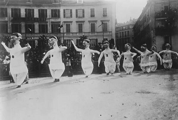 King Carnival at Nice. Masqueraders dancing in the streets. 27 January 1921