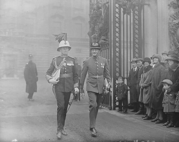 King holds an investiture. General Ogilvie and Air Commodore Munro, who both received the CBE
