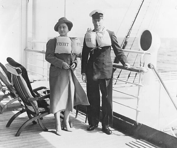 The King and Queen in their lifebelts on the liner Empress of Australia during a lifeboat drill